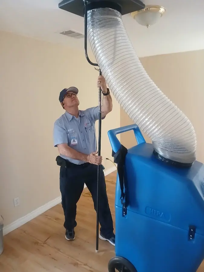 Furnace Tune-Up technician using HEPA equipment in Omak